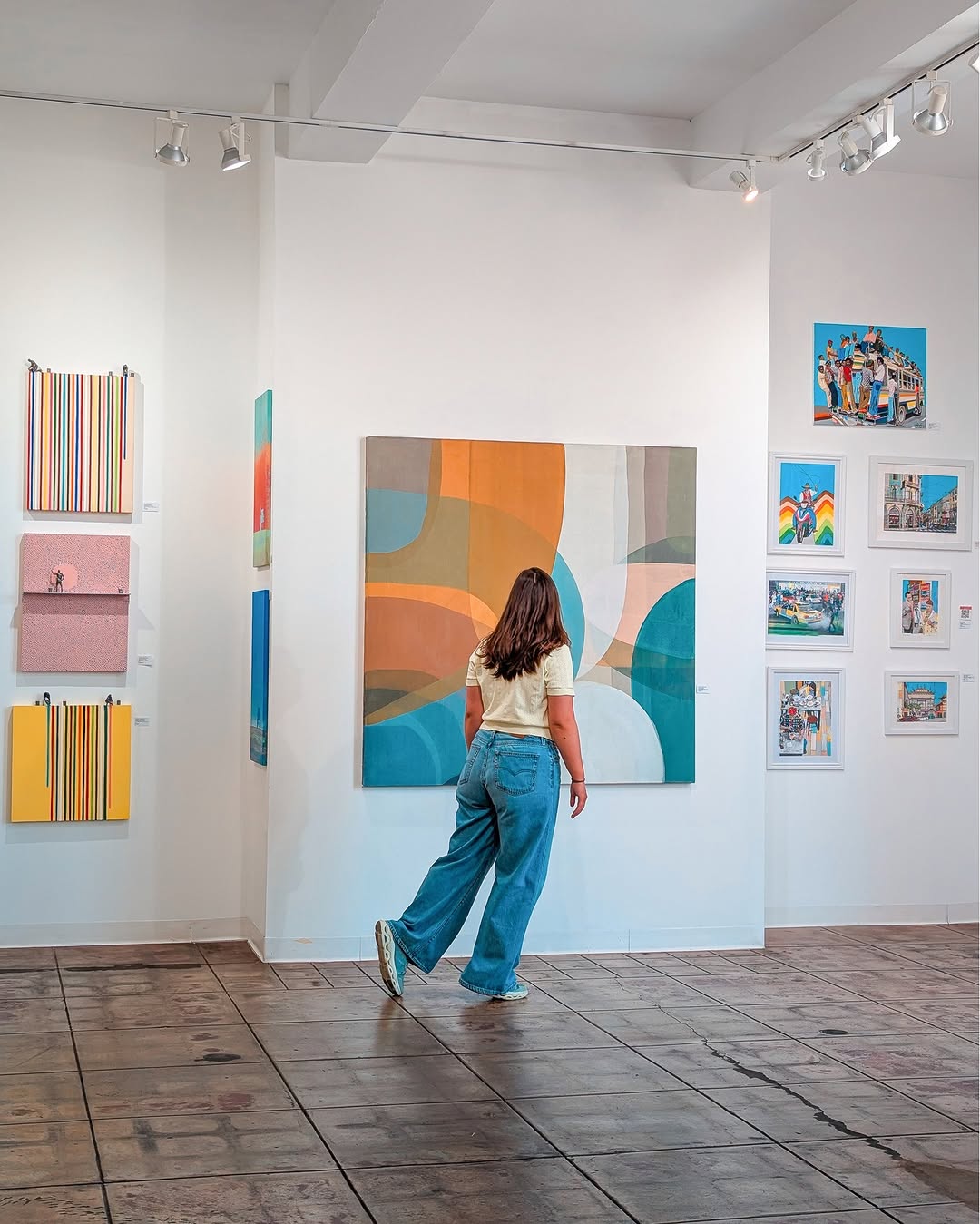 A visitor exploring original contemporary art at Artspace Warehouse